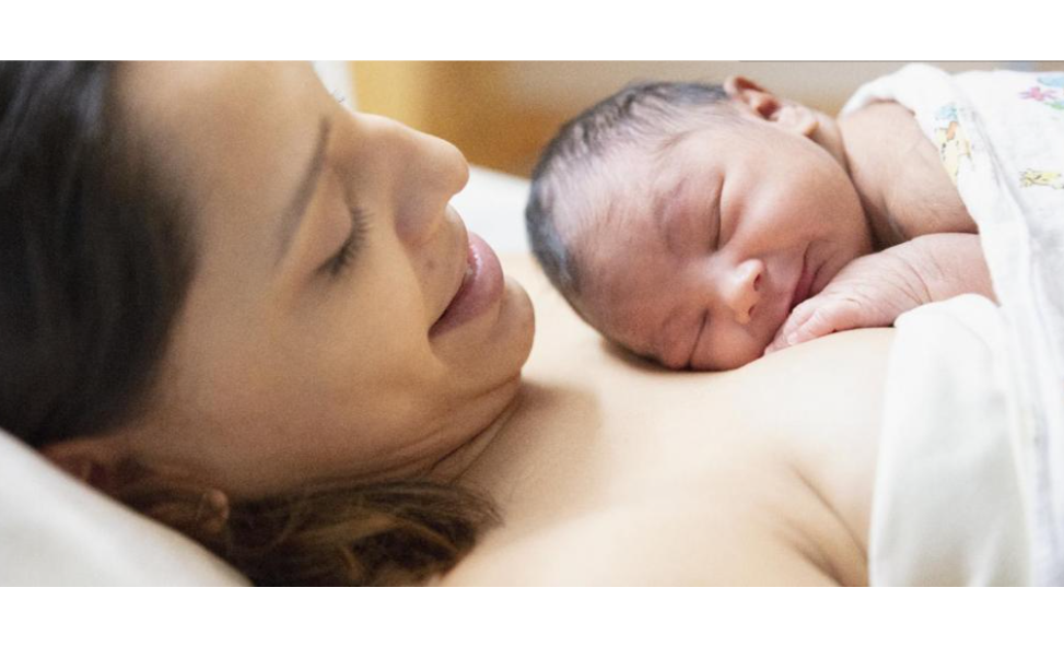 Mom holding newborn on chest